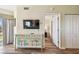 Hallway with TV console and doors to bedrooms at 12000 Gulf Blvd # 208-S, Treasure Island, FL 33706