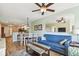 Living room with blue sofa and view into dining area and kitchen at 12000 Gulf Blvd # 208-S, Treasure Island, FL 33706
