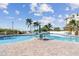Large resort-style pool with lounge chairs and tables at 12000 Gulf Blvd # 208-S, Treasure Island, FL 33706