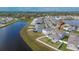 Aerial view of house near pond in residential community at 12783 Maple Bonsai Dr, Riverview, FL 33579