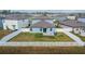 Home's backyard with white fence, grassy area, and patio at 12783 Maple Bonsai Dr, Riverview, FL 33579