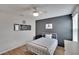 Bright bedroom with a metal bed frame and gray accent wall at 12783 Maple Bonsai Dr, Riverview, FL 33579
