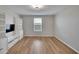 Bright bonus room with built-in shelving and hardwood floors at 12783 Maple Bonsai Dr, Riverview, FL 33579