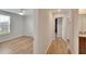 Hallway with light wood floors connecting bedrooms at 12783 Maple Bonsai Dr, Riverview, FL 33579