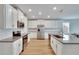 Modern kitchen with white cabinets, granite countertops, and stainless steel appliances at 12783 Maple Bonsai Dr, Riverview, FL 33579