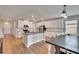 Modern kitchen with white cabinets, granite countertops, island, and stainless steel appliances at 12783 Maple Bonsai Dr, Riverview, FL 33579