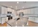 Modern kitchen with white cabinets, granite countertops, and stainless steel appliances at 12783 Maple Bonsai Dr, Riverview, FL 33579