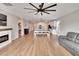 Open living room with kitchen views, fireplace, and hardwood floors at 12783 Maple Bonsai Dr, Riverview, FL 33579