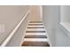 Modern staircase with wooden steps and white railing at 12783 Maple Bonsai Dr, Riverview, FL 33579