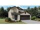 Two-story house with a dark brown garage door and landscaping at 13677 Newbridge St, Spring Hill, FL 34609