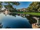 Scenic view of a pond with a fountain, reflecting the surrounding buildings and lush greenery at 14130 Rosemary Ln # 4311, Largo, FL 33774