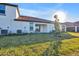 Home's backyard, showcasing patio and landscaping at 17523 Holly Well Ave, Wimauma, FL 33598