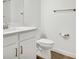 White bathroom vanity with quartz countertop and toilet at 17523 Holly Well Ave, Wimauma, FL 33598