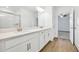 Bright bathroom with double vanity and access to bedroom at 17523 Holly Well Ave, Wimauma, FL 33598