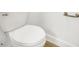 Simple, clean bathroom with toilet and wood flooring at 17523 Holly Well Ave, Wimauma, FL 33598