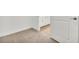 Spacious bedroom with carpet and an open door to the bathroom at 17523 Holly Well Ave, Wimauma, FL 33598