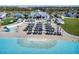Aerial view of resort-style pool with beach entry and cabanas at 17523 Holly Well Ave, Wimauma, FL 33598