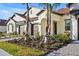 Two-story home with tile roof, two-car garage, and landscaped yard at 17523 Holly Well Ave, Wimauma, FL 33598