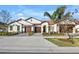 Tan two-story home with tile roof and attached two-car garage at 17523 Holly Well Ave, Wimauma, FL 33598