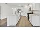 Modern kitchen with white cabinets, stainless steel appliances and light gray countertops at 17523 Holly Well Ave, Wimauma, FL 33598