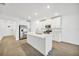 Modern kitchen with white cabinets, stainless steel appliances, and a large island at 17523 Holly Well Ave, Wimauma, FL 33598