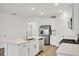 Modern kitchen with white cabinets, stainless steel appliances and a large island at 17523 Holly Well Ave, Wimauma, FL 33598