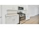 Modern kitchen with stainless steel appliances and white shaker cabinets at 17523 Holly Well Ave, Wimauma, FL 33598