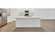 Kitchen island with white quartz countertop and stainless steel appliances at 17523 Holly Well Ave, Wimauma, FL 33598