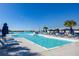 Relaxing lagoon pool with lounge chairs at 17523 Holly Well Ave, Wimauma, FL 33598