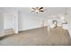 Open living room with tile floors and a view into the kitchen at 17523 Holly Well Ave, Wimauma, FL 33598
