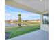 Covered patio overlooking a tranquil lake at 17523 Holly Well Ave, Wimauma, FL 33598