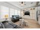 Relaxing living room with comfy leather seating, built-in shelving, and wood-look floors at 19915 Gulf Blvd # 805, Indian Shores, FL 33785