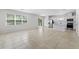 Bright living room with tile floors and kitchen view at 20602 Monza Loop, Land O Lakes, FL 34638