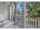 Relaxing balcony with white rocking chairs and a view of a tree-lined street at 2204 W Horatio St, Tampa, FL 33606