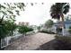 Charming backyard patio with white picket fence and water views at 249 Boca Ciega Dr, Madeira Beach, FL 33708