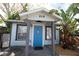 Quaint cottage with blue door, gray trim, and a small covered porch at 249 Boca Ciega Dr, Madeira Beach, FL 33708