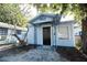 Quaint light blue house with black door at 249 Boca Ciega Dr, Madeira Beach, FL 33708