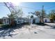 Three houses near the waterfront, one with a for sale sign at 249 Boca Ciega Dr, Madeira Beach, FL 33708