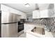 Modern kitchen with stainless steel appliances at 249 Boca Ciega Dr, Madeira Beach, FL 33708