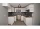 Efficient kitchen with white cabinets and granite countertops at 249 Boca Ciega Dr, Madeira Beach, FL 33708
