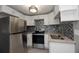Modern kitchen with stainless steel appliances and white cabinets at 249 Boca Ciega Dr, Madeira Beach, FL 33708