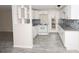 Renovated kitchen with white cabinets, granite counters, and tile backsplash at 249 Boca Ciega Dr, Madeira Beach, FL 33708