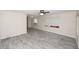 Bright living room featuring gray wood-look tile floors and ceiling fan at 249 Boca Ciega Dr, Madeira Beach, FL 33708