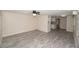 Open living room with gray tile floors and a view into the kitchen at 249 Boca Ciega Dr, Madeira Beach, FL 33708