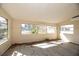 Sun-drenched sunroom with multiple windows and tile floors at 249 Boca Ciega Dr, Madeira Beach, FL 33708