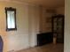 Spacious living room with a large TV and decorative mirror at 2515 Ragins Ln, Plant City, FL 33567