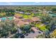 Scenic aerial view of a community with pool, clubhouse, and tennis courts at 2740 Highlands Blvd # D, Palm Harbor, FL 34684