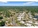 Aerial view of the community with lush greenery and surrounding homes at 2740 Highlands Blvd # D, Palm Harbor, FL 34684