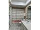 Well-lit bathroom with a shower, toilet, and vanity at 2740 Highlands Blvd # D, Palm Harbor, FL 34684