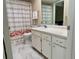 Bathroom with white vanity, flamingo-themed shower curtain, and tile floors at 2740 Highlands Blvd # D, Palm Harbor, FL 34684